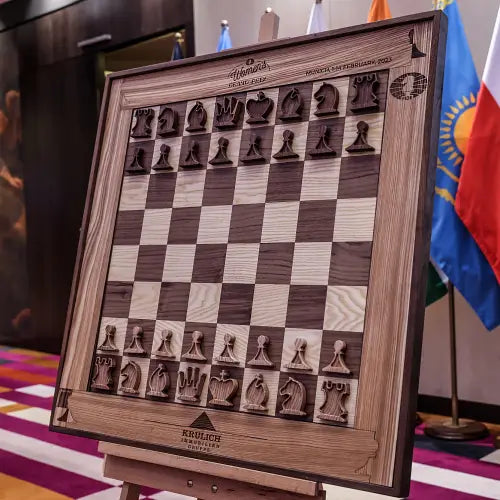 The greatest female chess player of all time, Judit Polgár, with the ChessboArt creator and a Morgan Stanley representative, showcasing two luxury vertical wall-mounted chess sets in Hungary.