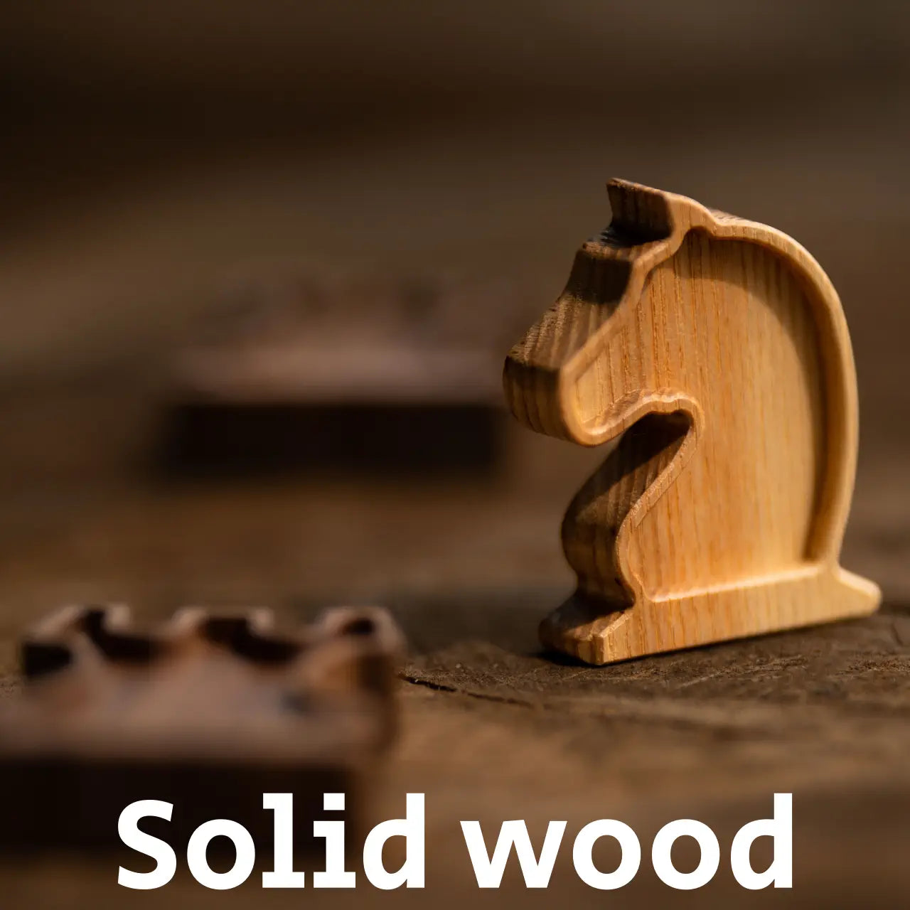 Detail of a Solid Wood chess piece: Light Ash Knight on a blurred background. Highlights natural wood grain.