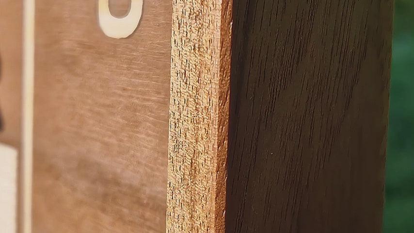 A hanging wooden chessboard, hanging like a picture in a solid wooden frame and featuring wooden chess pieces with hidden magnets.